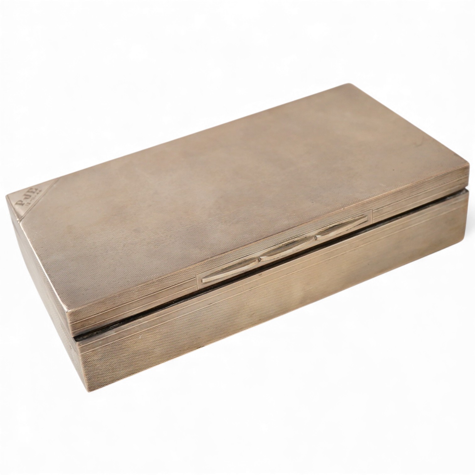 A George VI engine turned silver mounted rectangular cigarette box, by A. Wilcox, Birmingham, 1938, 17cm, with engraved inscription.